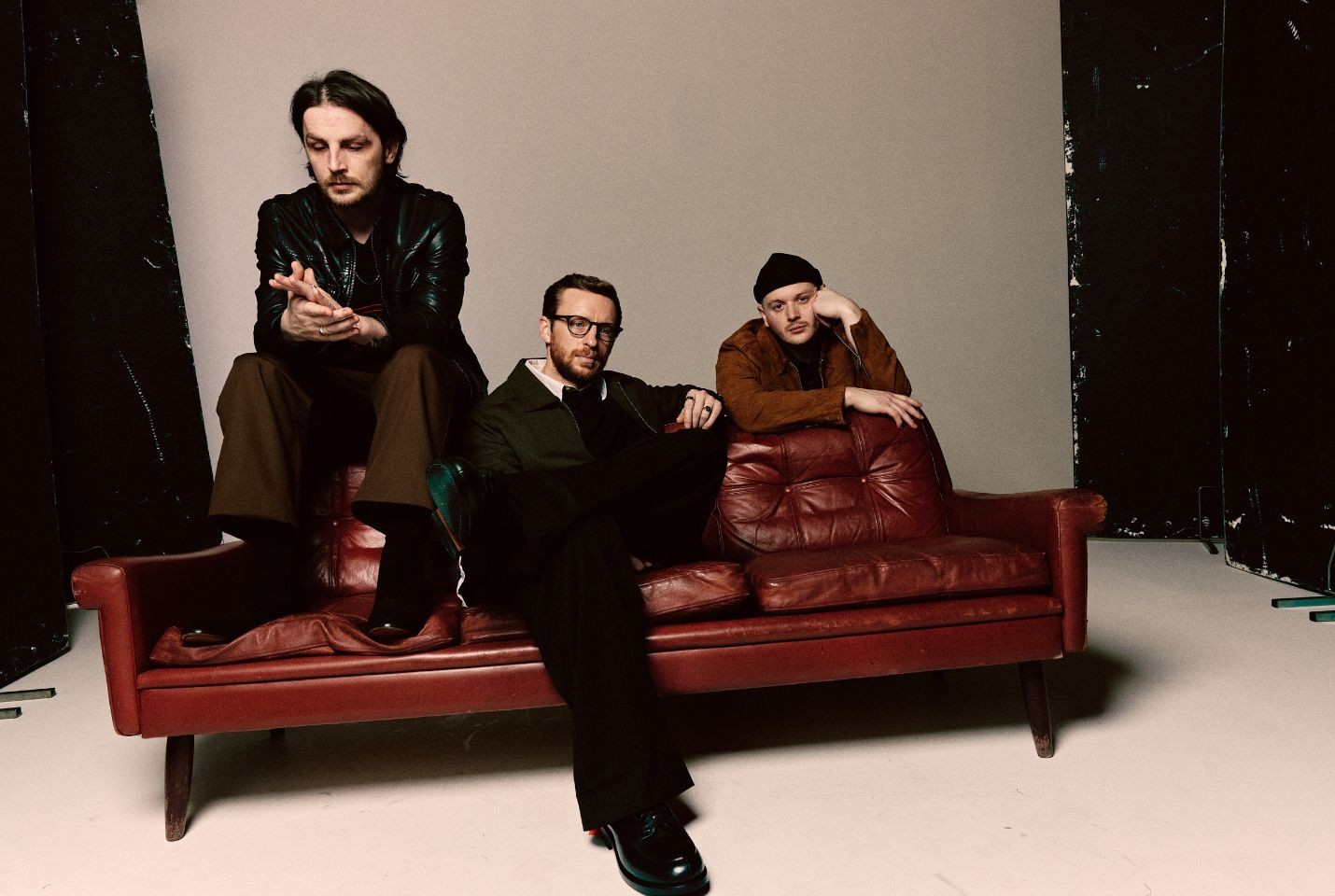 Skinny Living sat on a red leather coach